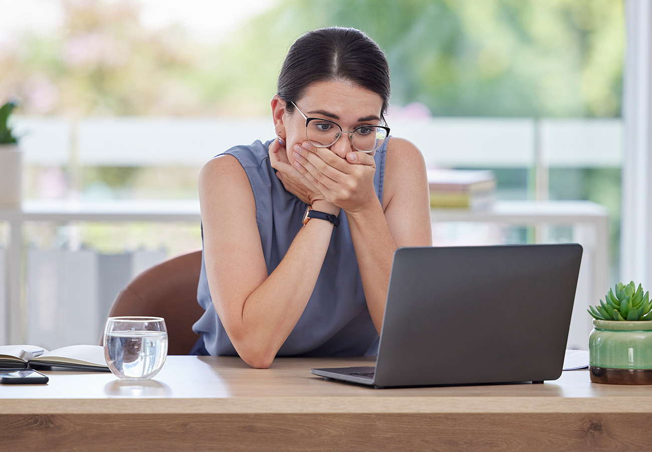 Staff member in shock covering mouth as they have sent the information to the wrong person